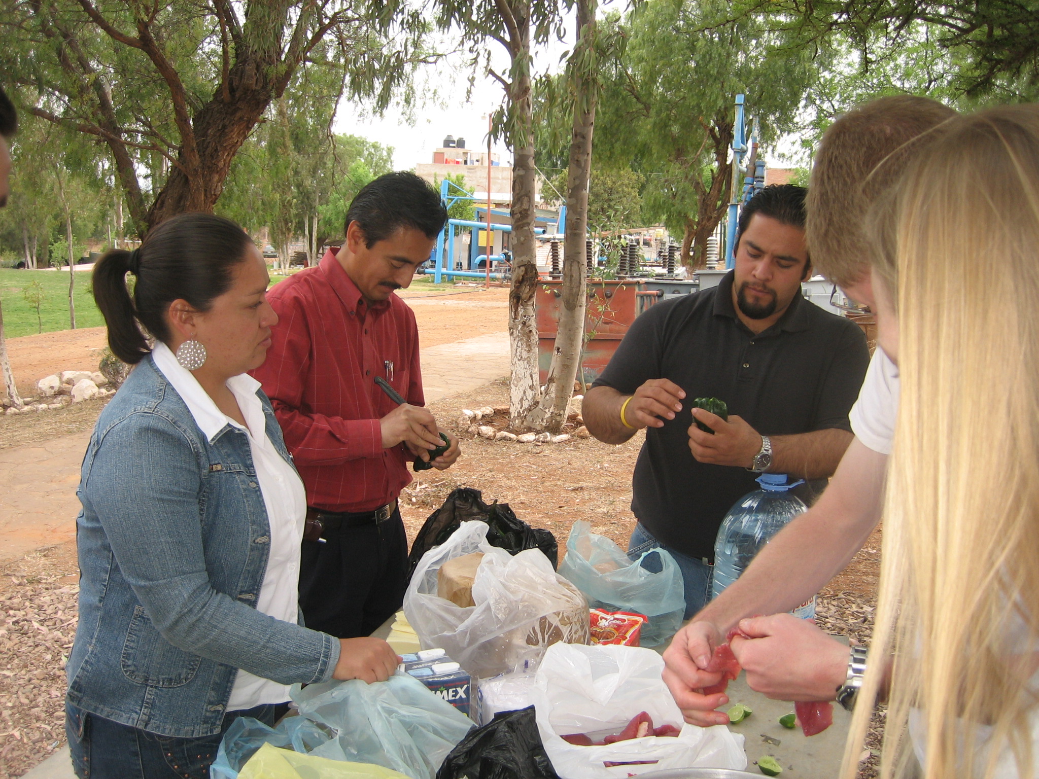 Sara, Prof. Dzul, Jonathan, Derek, and Daniel
		 prepare for a barbecue.